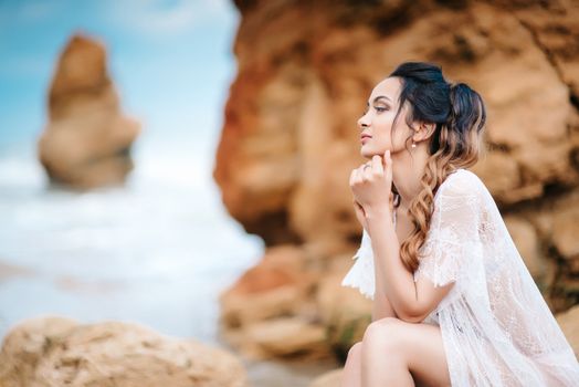 young girl bride in her underwear on the shore of the sea dreams of the future