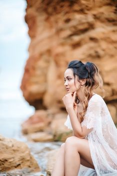 young girl bride in her underwear on the shore of the sea dreams of the future