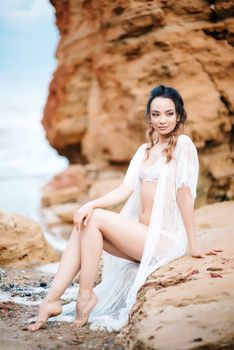 young girl bride in her underwear on the shore of the sea dreams of the future