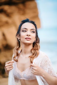 young girl bride in her underwear on the shore of the sea dreams of the future