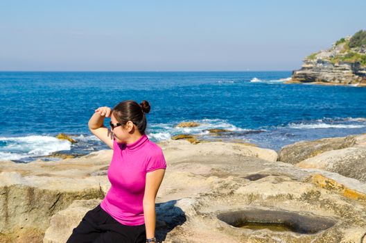 Asian girl explores the coastline of Bondi Beach in Sydney,Australia.