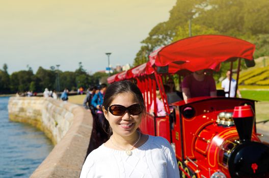 Sydney Australia, girl standing in front of tourist train in botanical gardens