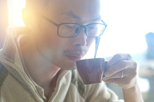 Man drinking coffee at cafe in the morning