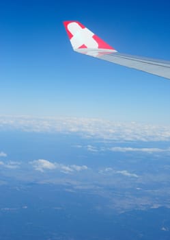 Plain wing over blue sky , travel on the plain.