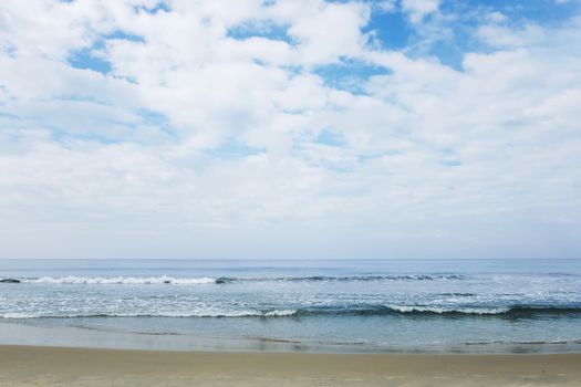 Indian Ocean in calm weather with small waves and clouds