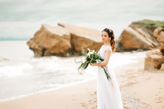 young bride on a sandy beach at a wedding walk