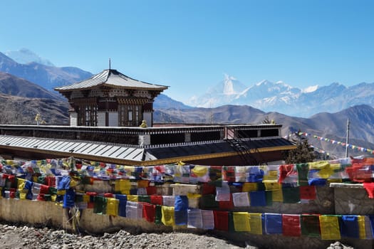 The Buddhist monastery is high in the mountains with a large number of flags, near Muktinath