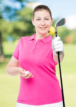 Woman golfer holding a stick and a ball on a background of golf courses