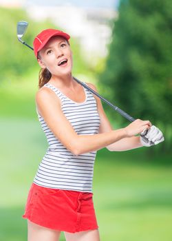 Golfer in cap with golf club on a background of golf courses