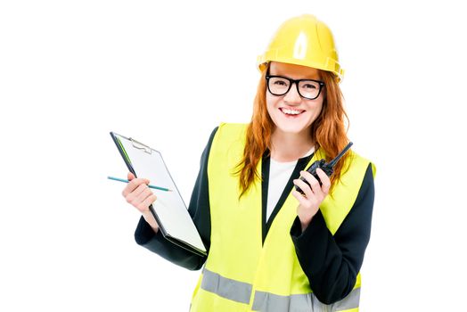 happy woman builder in protective clothes on white background with walkie-talkie