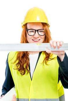portrait of an engineer woman with a ruler on a white background