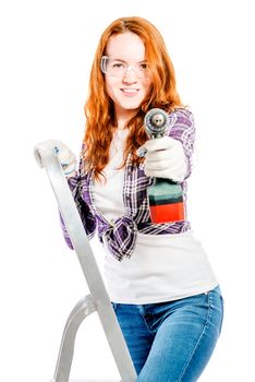 vertical portrait of a woman on a stepladder with a drill isolated