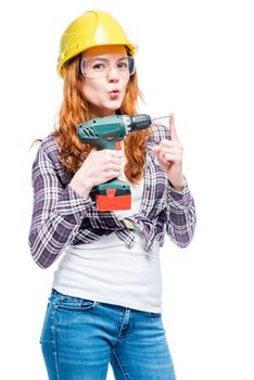 woman with a drill in protective clothes doing home repair, portrait isolated