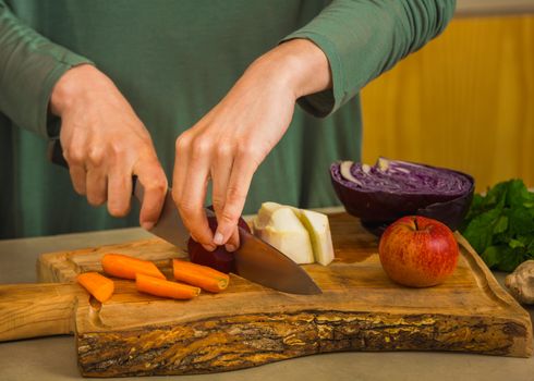 Several vegetables on top of a wooden board. Ingredients for detox juice.
