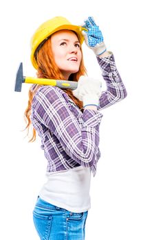 woman in a helmet with a hammer looking up on a white background