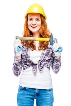 woman with a male profession on a white background holds a hammer