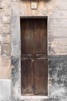 Old wooden door in brick wall