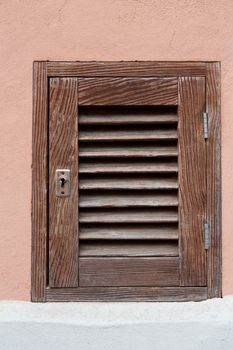 Old wooden window in brick wall