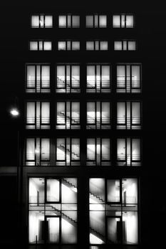 Tall building with lighted windows at night
