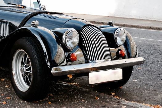 Black old classic car on the road in Richmond, London