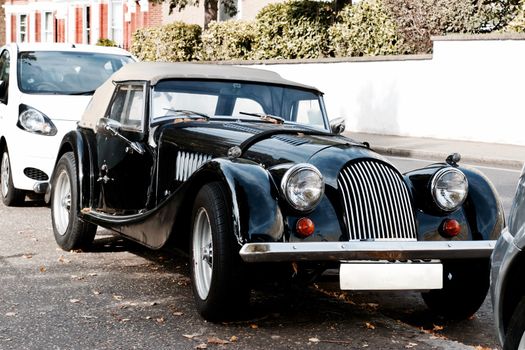 Black old classic car on the road in Richmond, London