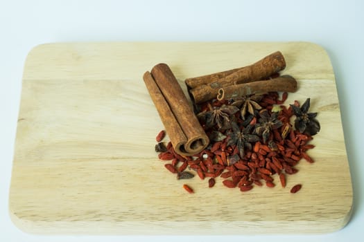 Traditional chinese dried herbs on a wooden chopping board