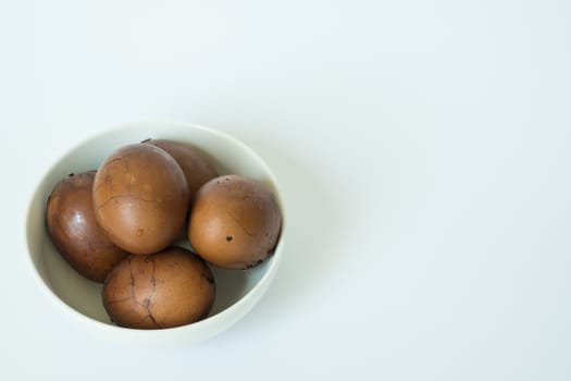 Tradional chinese herbal eggs in a white bowl