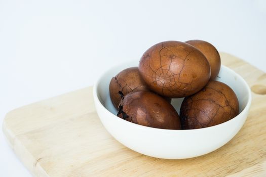 Tradional chinese herbal eggs in a white bowl