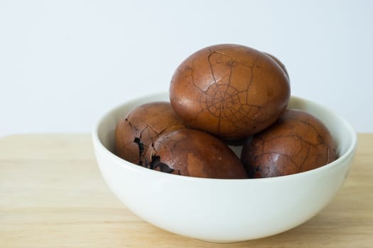 Tradional chinese herbal eggs in a white bowl