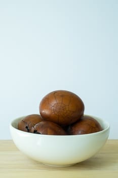 Tradional chinese herbal eggs in a white bowl