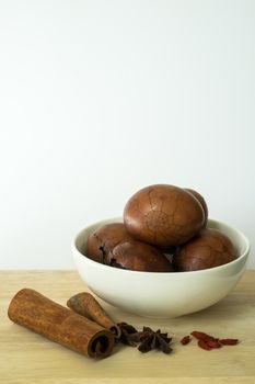 Tradional chinese herbal eggs in a white bowl