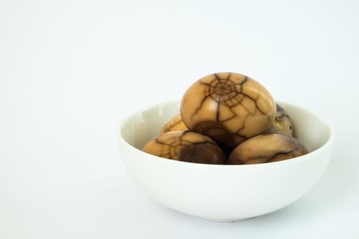 Tradional chinese herbal eggs in a white bowl