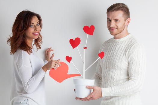 Happy couple growing tree of love, Valentines day wedding concept