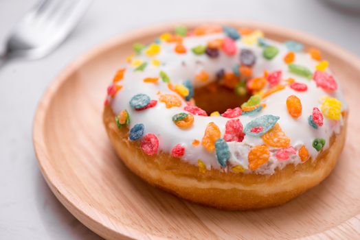 Plate with delicious donuts on marble background.