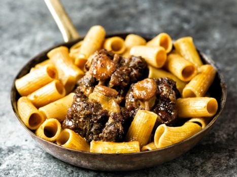 close up of a pan of rustic italian oxtail ragu pasta