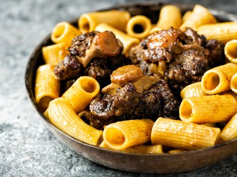close up of a pan of rustic italian oxtail ragu pasta