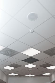 Office room ceiling with smoke detector and alarm