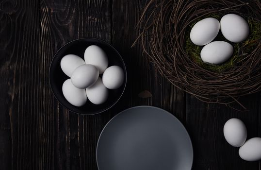 Easter eggs and bird nest on a rustic wooden table