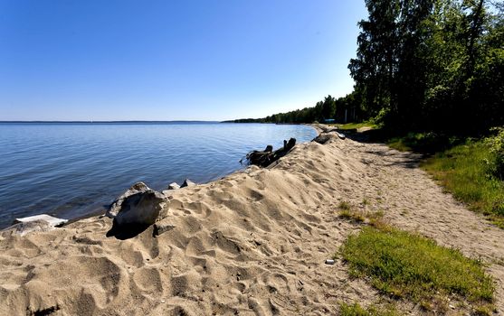 quiet lake Uvildy early in the morning, clear water, clear bottom,sandy beach, South Ural