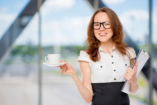 businesswoman with a cup of coffee in the office