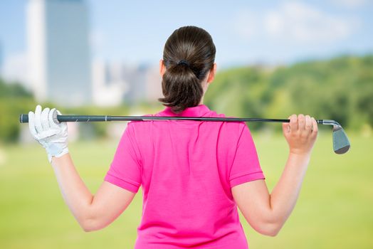 back is athletes with equipment for playing golf on a background of golf courses