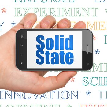 Science concept: Hand Holding Smartphone with  blue text Solid State on display,  Tag Cloud background, 3D rendering
