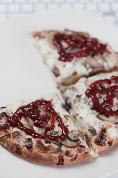 Fresh and tasty pizza near computer white keyboard. Red ketchup concept.