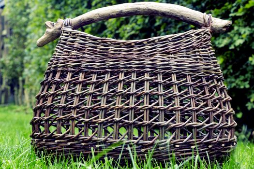 Basket of wicker on green grass on a sunny day.