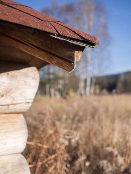 Corner of a wooden hut with a view of the nature