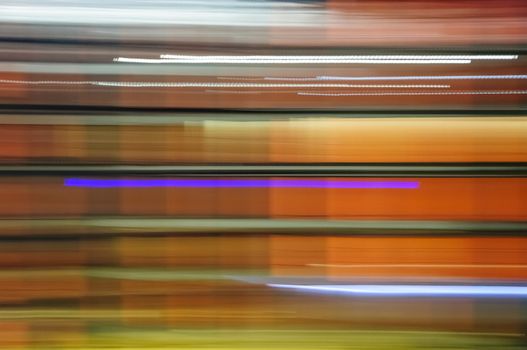 Abstract colorful image, shutter drag of night lit business building
