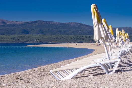 Sun chairs lined up on Zlatni rat beach, Bol, Island of Brac, Croatia, Dalmatia