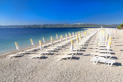 Sun chairs lined up on Zlatni rat beach, Bol, Island of Brac, Croatia, Dalmatia