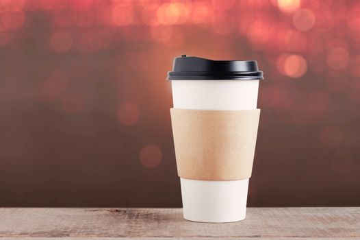 Cup of coffee on wood with colorful background.