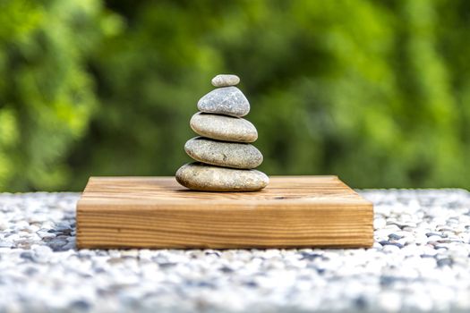 Zen stones on wood with green background